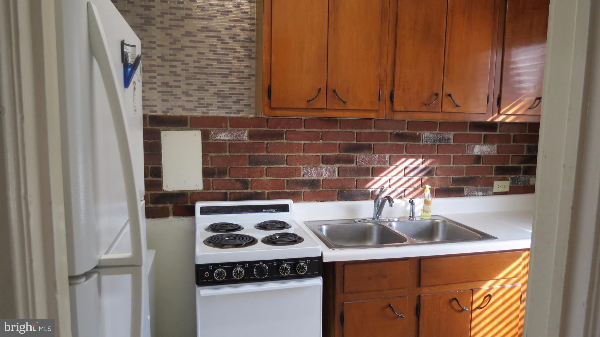 54 Ridge Road, Unit K Greenbelt, MD 20770 - Photo 3 of 29 a kitchen with a sink and a stove top oven