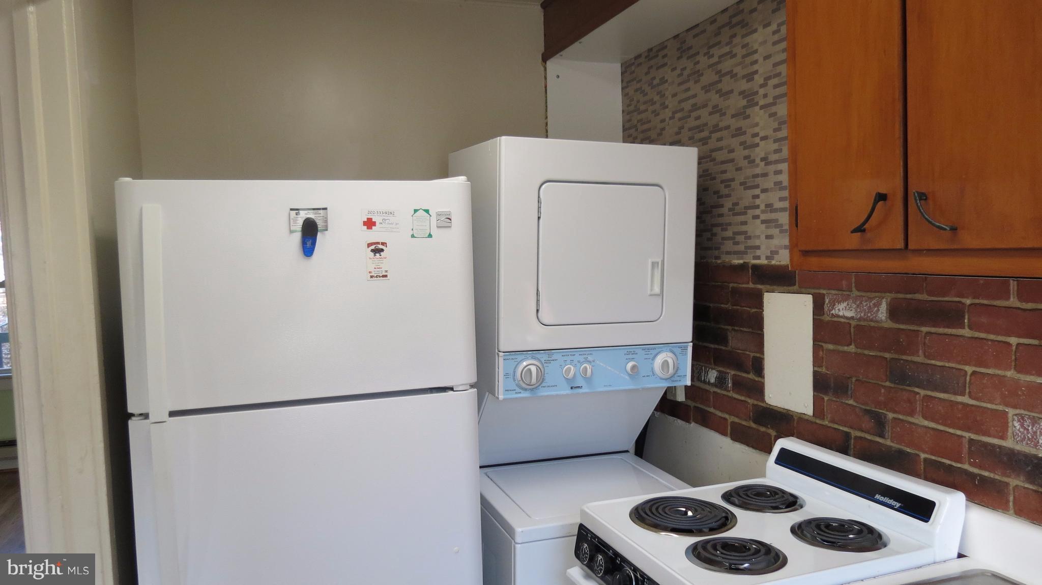 54 Ridge Road, Unit K Greenbelt, MD 20770 - Photo 5 of 29 a white refrigerator freezer and a stove sitting inside of a kitchen
