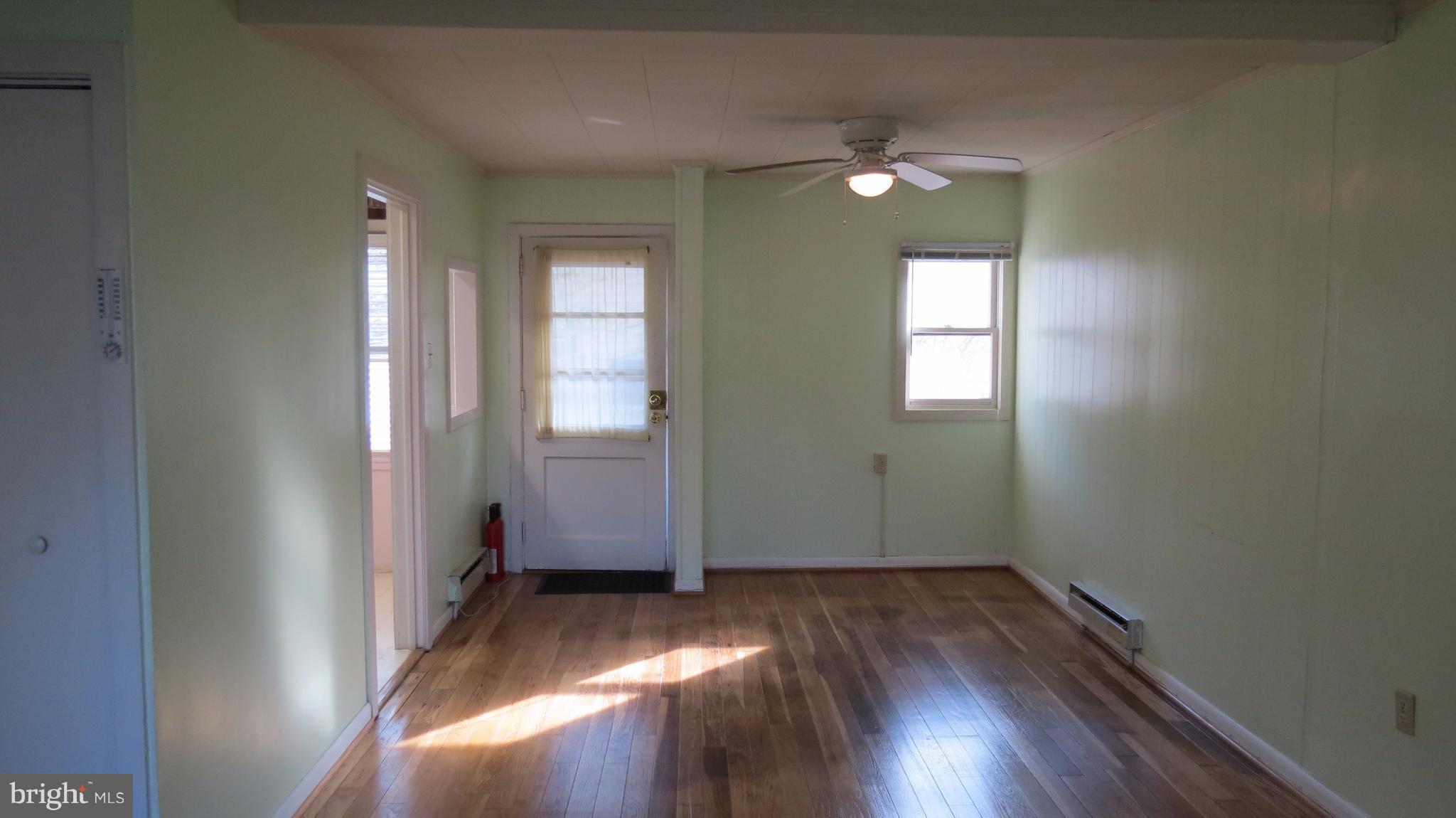 54 Ridge Road, Unit K Greenbelt, MD 20770 - Photo 7 of 29 an empty room with wooden floor and windows