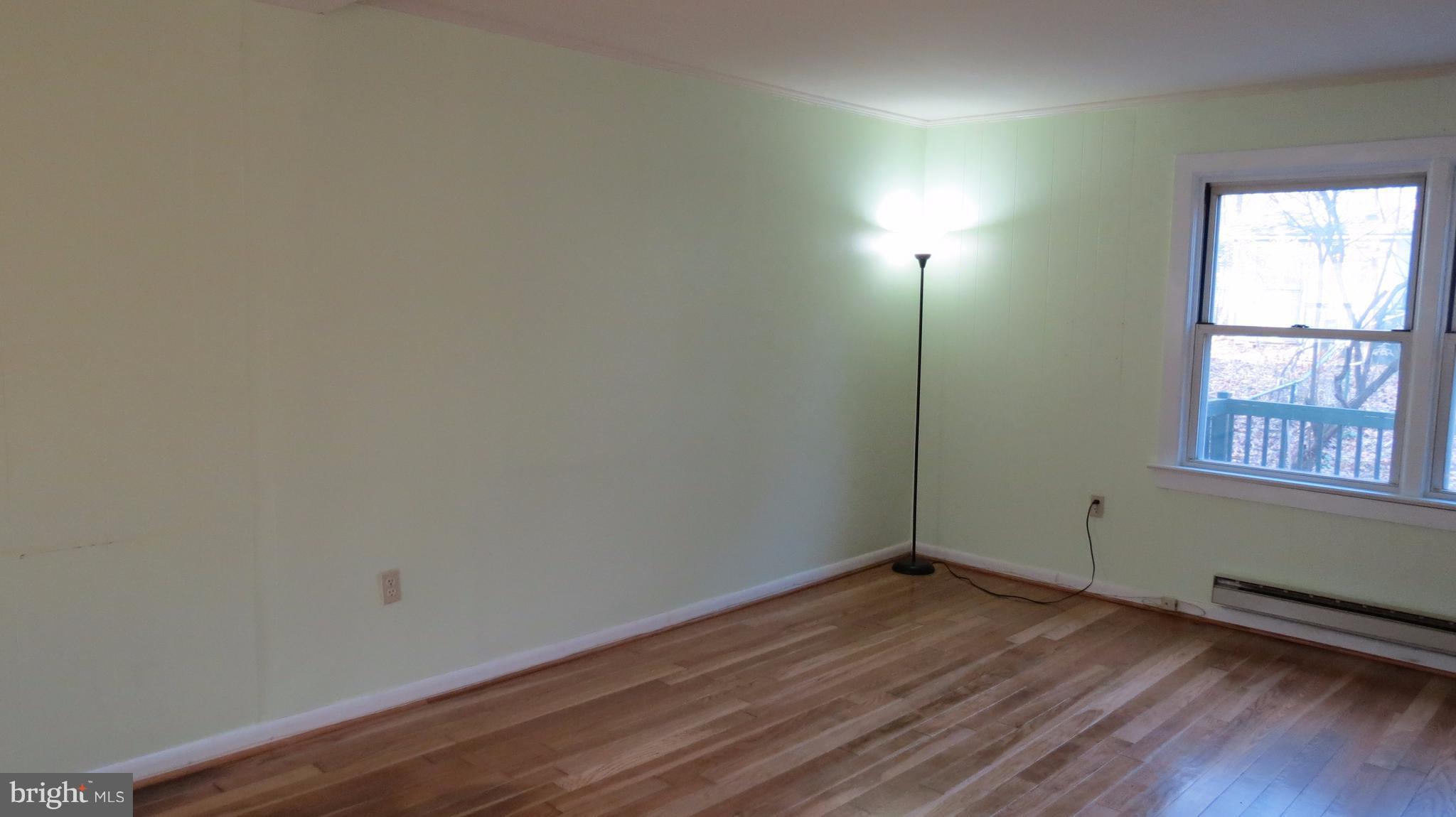 54 Ridge Road, Unit K Greenbelt, MD 20770 - Photo 8 of 29 an empty room with wooden floor and windows