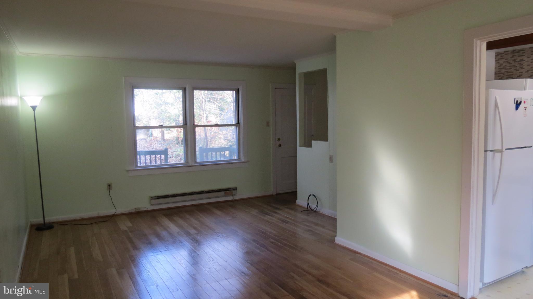 54 Ridge Road, Unit K Greenbelt, MD 20770 - Photo 9 of 29 an empty room with wooden floor and windows