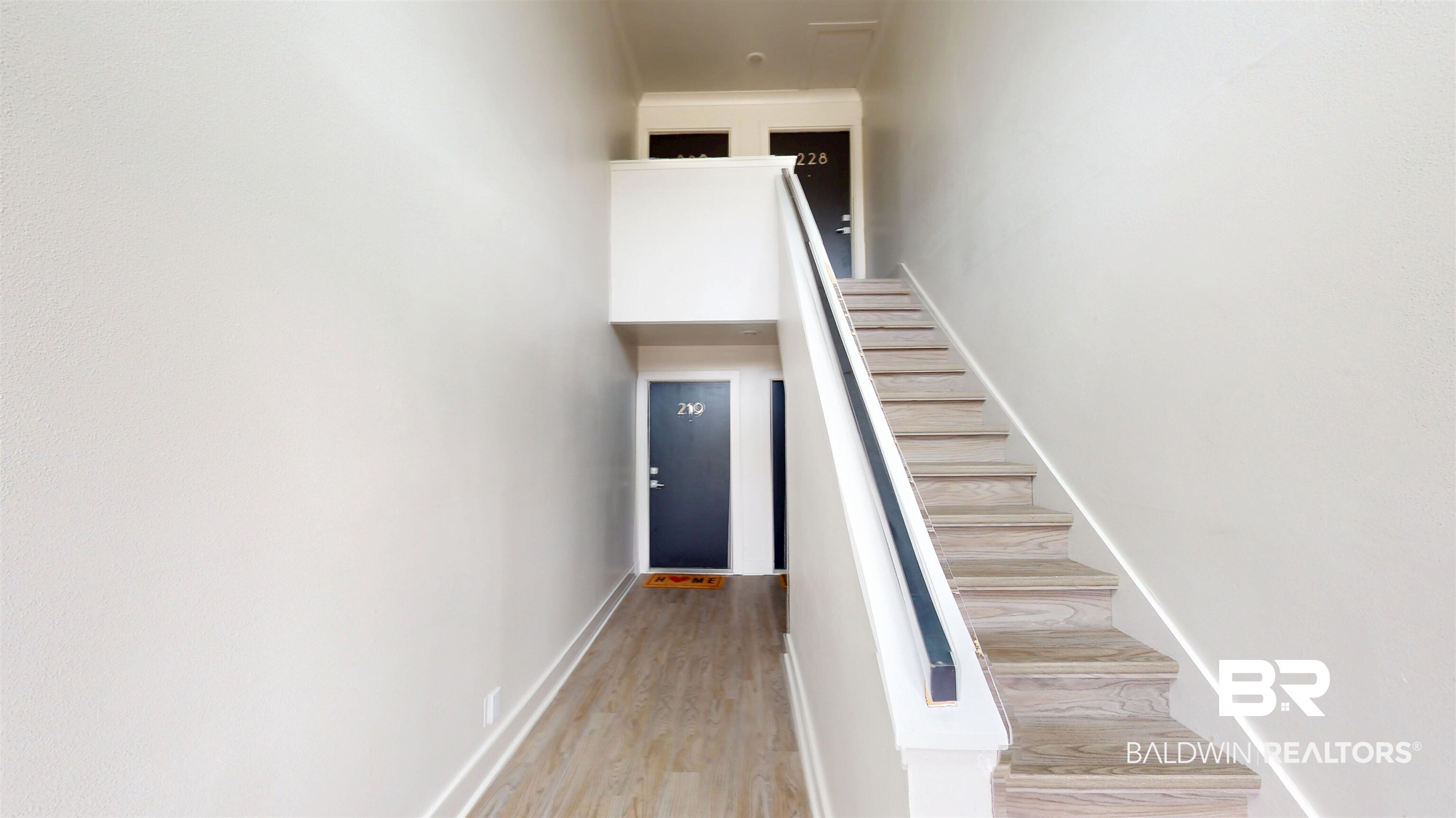 3655 Old Shell Road, Unit 219 Mobile, AL 36608 - Photo 3 of 25 Staircase featuring wood finished floors and baseboards