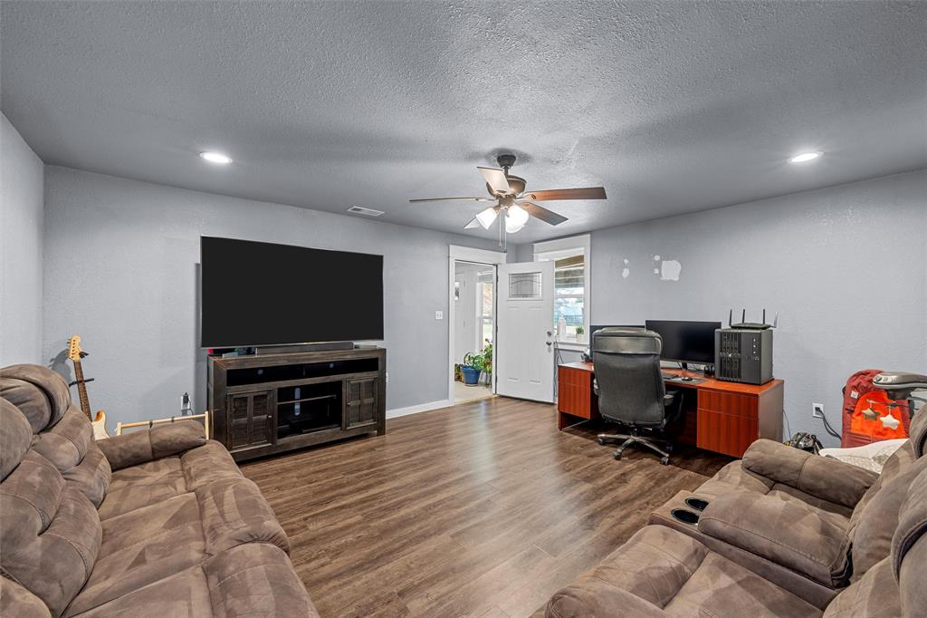 221 Saffle Road Robinson, TX 76706 - Photo 11 of 40 a living room with furniture and a flat screen tv
