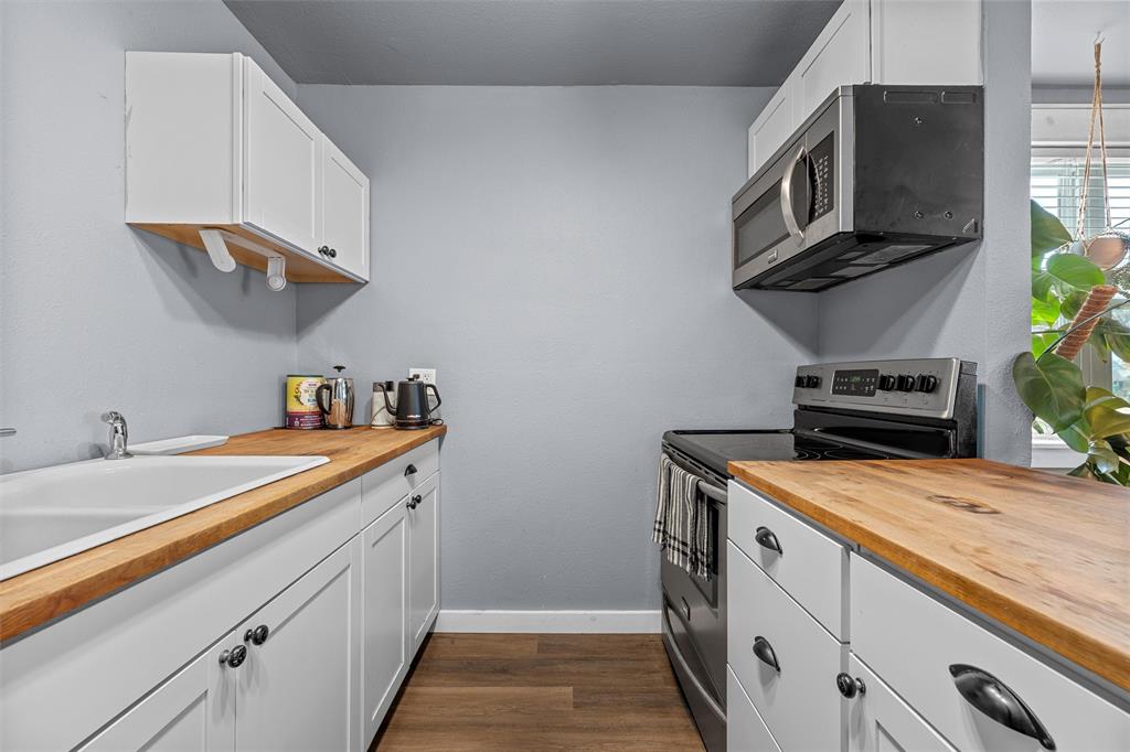 221 Saffle Road Robinson, TX 76706 - Photo 12 of 40 a kitchen with stainless steel appliances granite countertop a sink and a stove