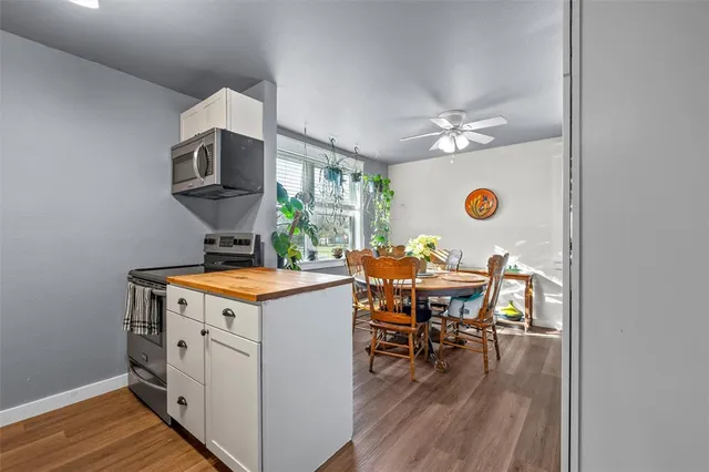a kitchen with a stove and a dining table