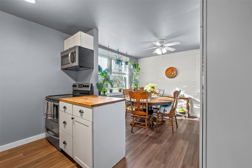 221 Saffle Road Robinson, TX 76706 - Photo 13 of 40 a kitchen with a stove and a dining table