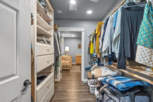 a view of a hallway with wooden floor and furniture