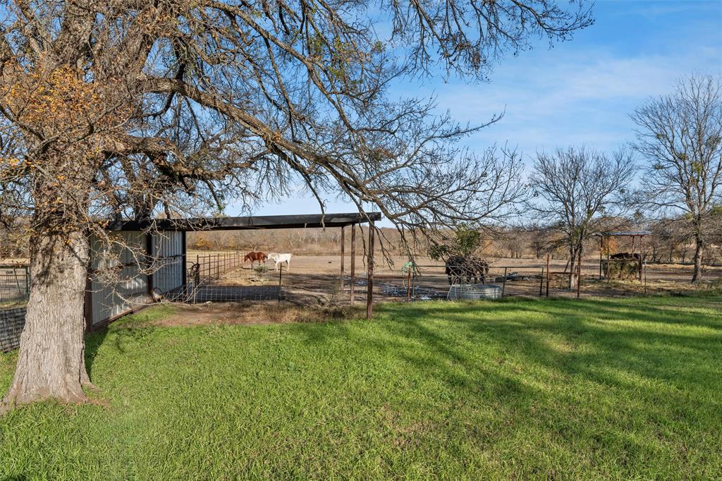 221 Saffle Road Robinson, TX 76706 - Photo 30 of 40 a backyard of a house with table and chairs