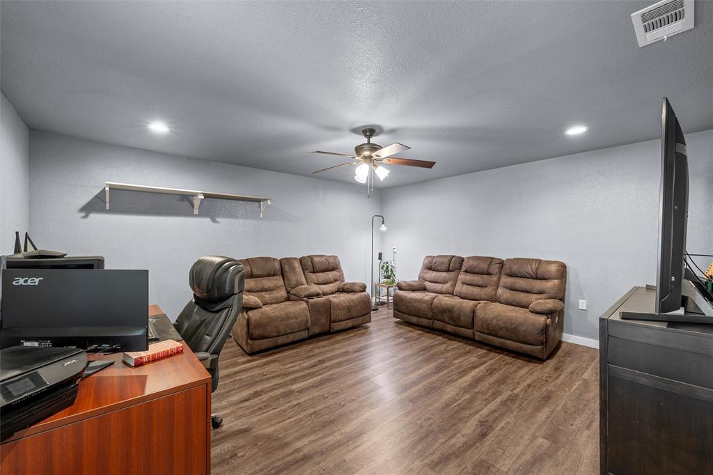 221 Saffle Road Robinson, TX 76706 - Photo 10 of 40 a living room with furniture and a flat screen tv