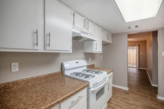a kitchen with stainless steel appliances granite countertop a stove and a sink