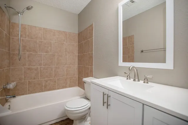 a bathroom with a sink toilet and bathtub