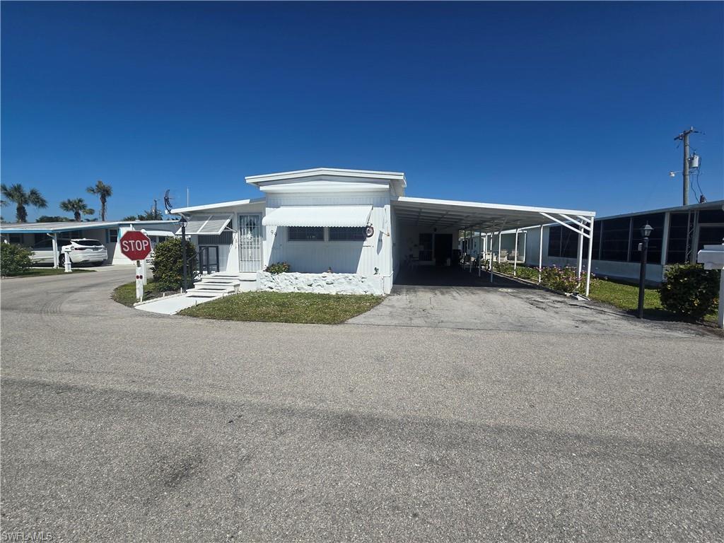 99 Moorhead Manor, Unit 99 Naples, FL 34112 - Photo 1 of 26 a view of a house with a yard