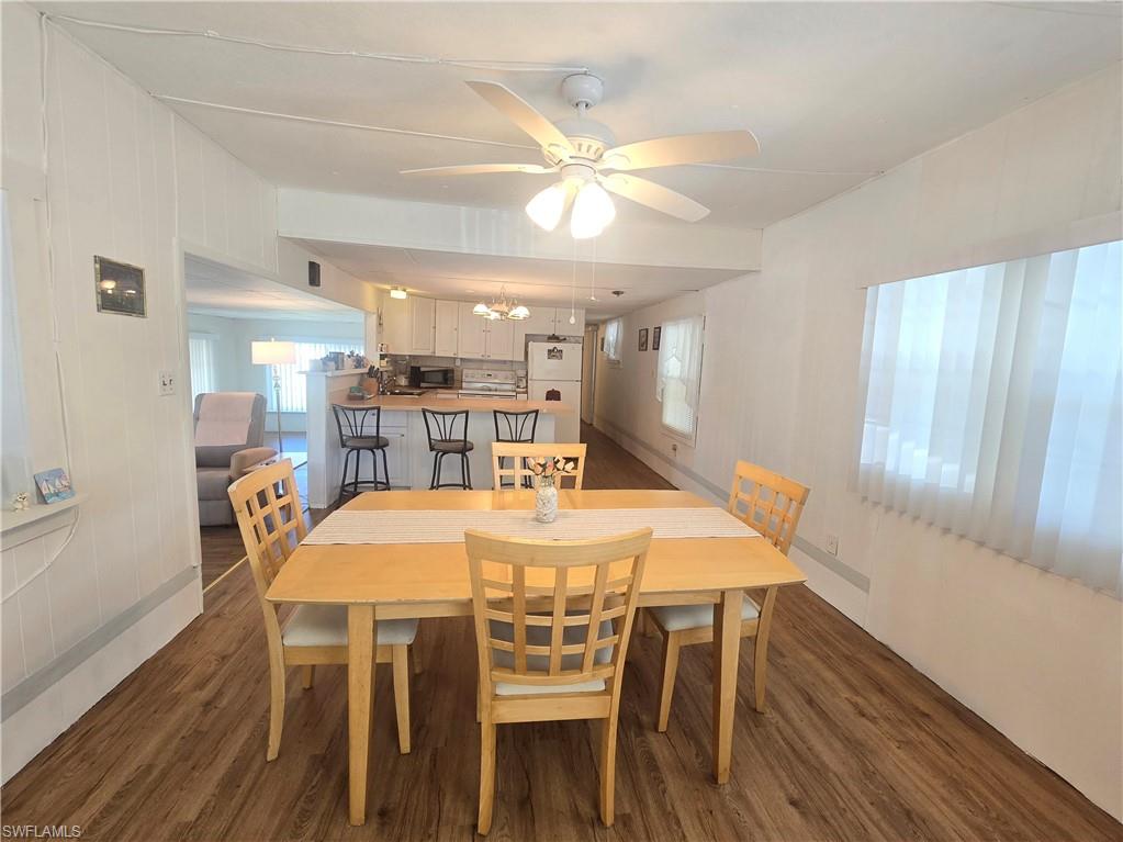 99 Moorhead Manor, Unit 99 Naples, FL 34112 - Photo 12 of 26 a view of a dining room with furniture and wooden floor