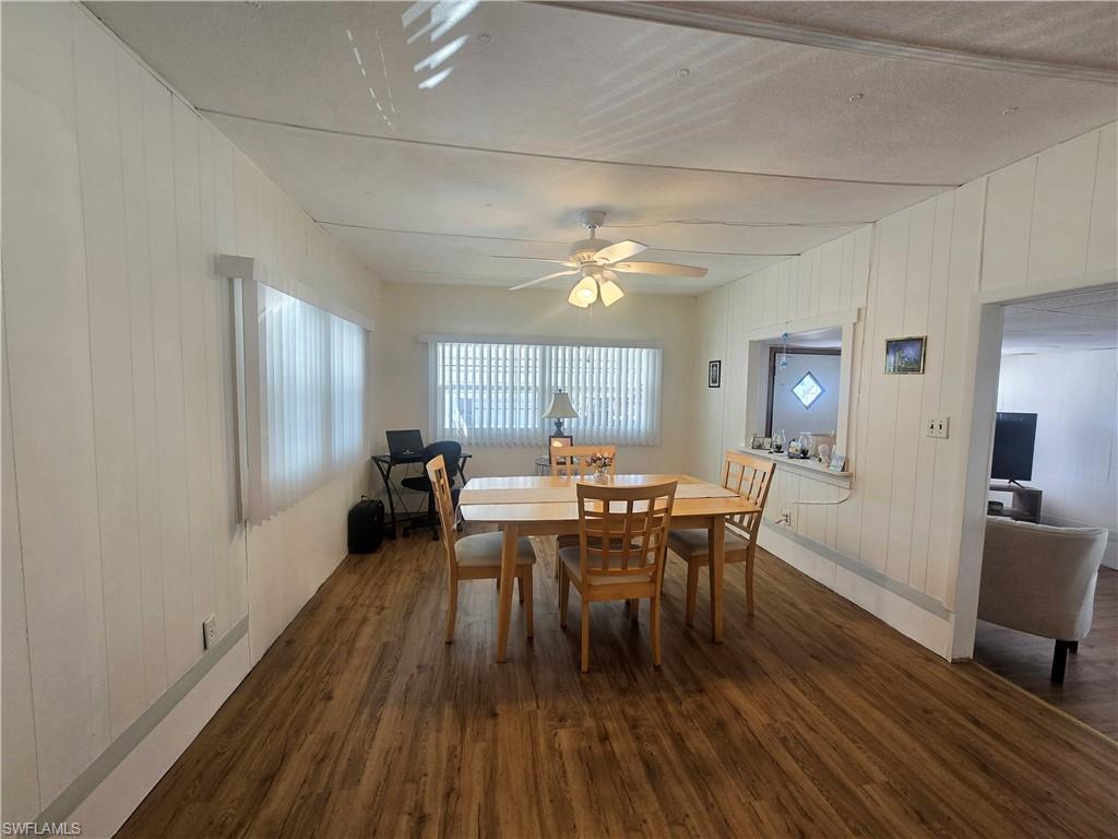 99 Moorhead Manor, Unit 99 Naples, FL 34112 - Photo 13 of 26 a view of a dining room with furniture window and wooden floor