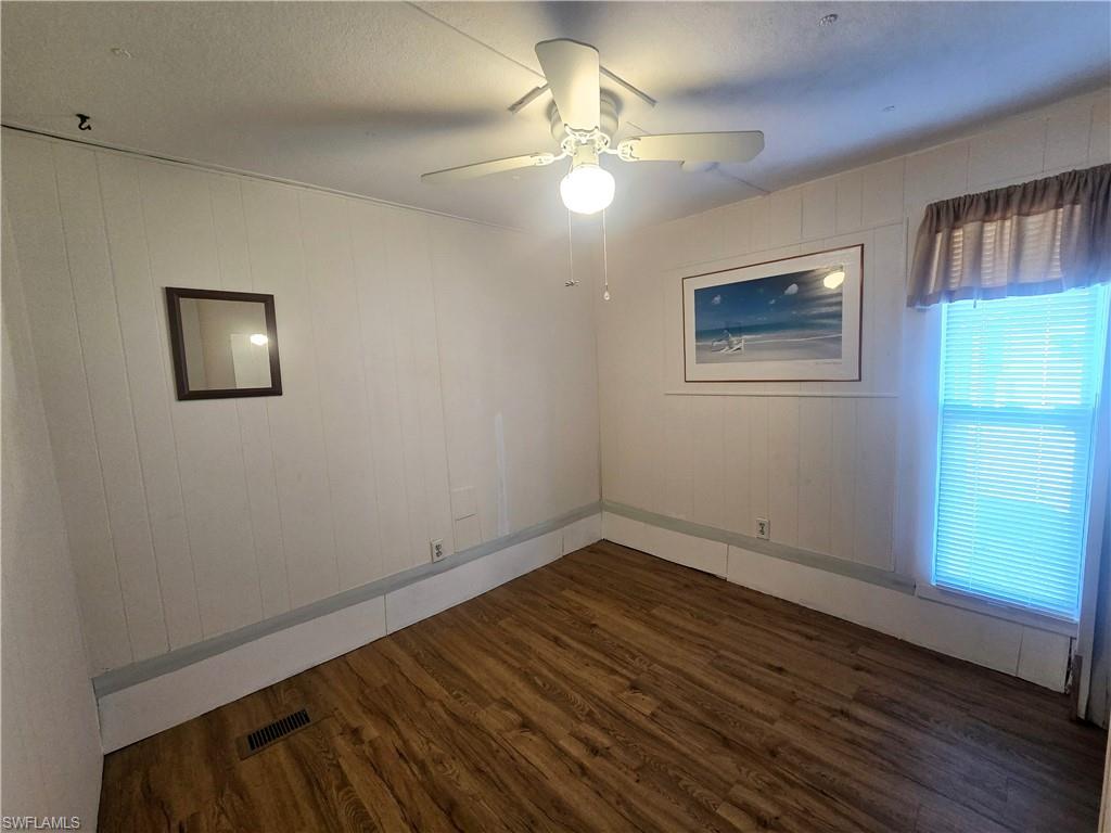 99 Moorhead Manor, Unit 99 Naples, FL 34112 - Photo 17 of 26 a view of empty room with wooden floor and fan