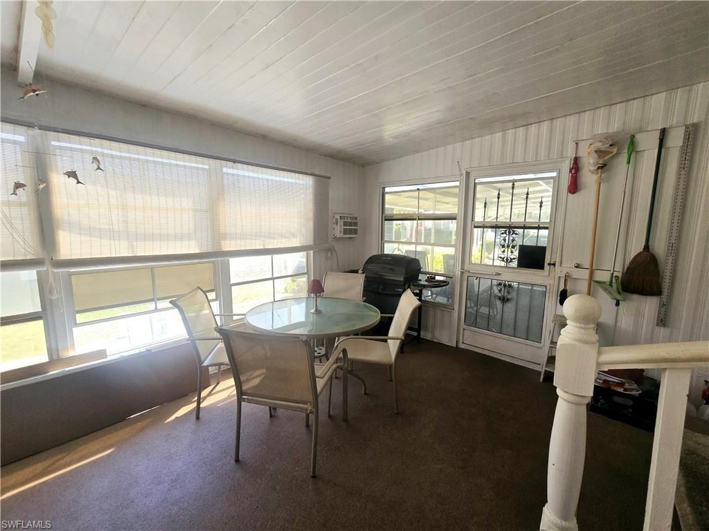 99 Moorhead Manor, Unit 99 Naples, FL 34112 - Photo 19 of 26 a view of a livingroom with furniture and a window