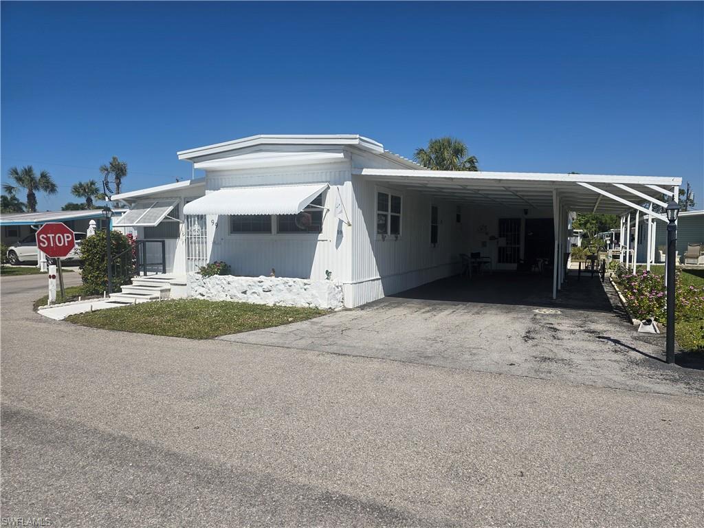 99 Moorhead Manor, Unit 99 Naples, FL 34112 - Photo 23 of 26 a view of a house with a porch