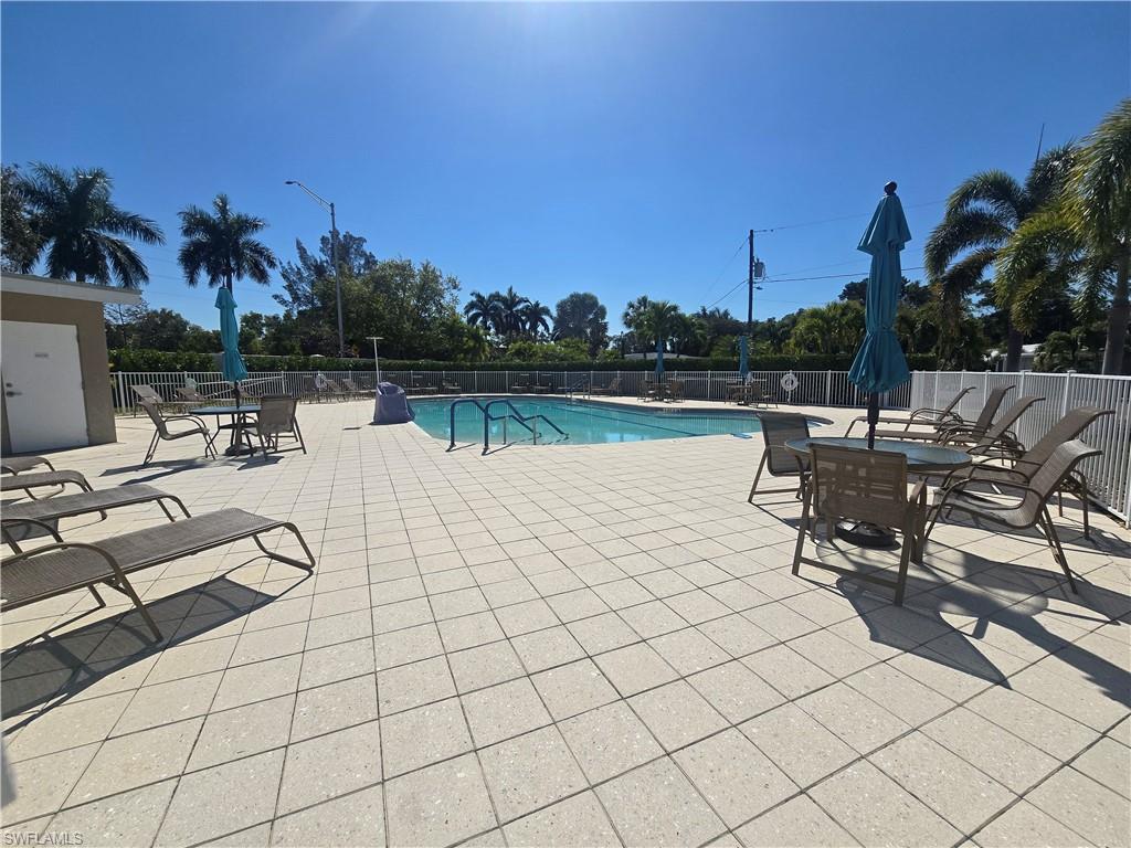 99 Moorhead Manor, Unit 99 Naples, FL 34112 - Photo 24 of 26 a view of a lake with outdoor seating