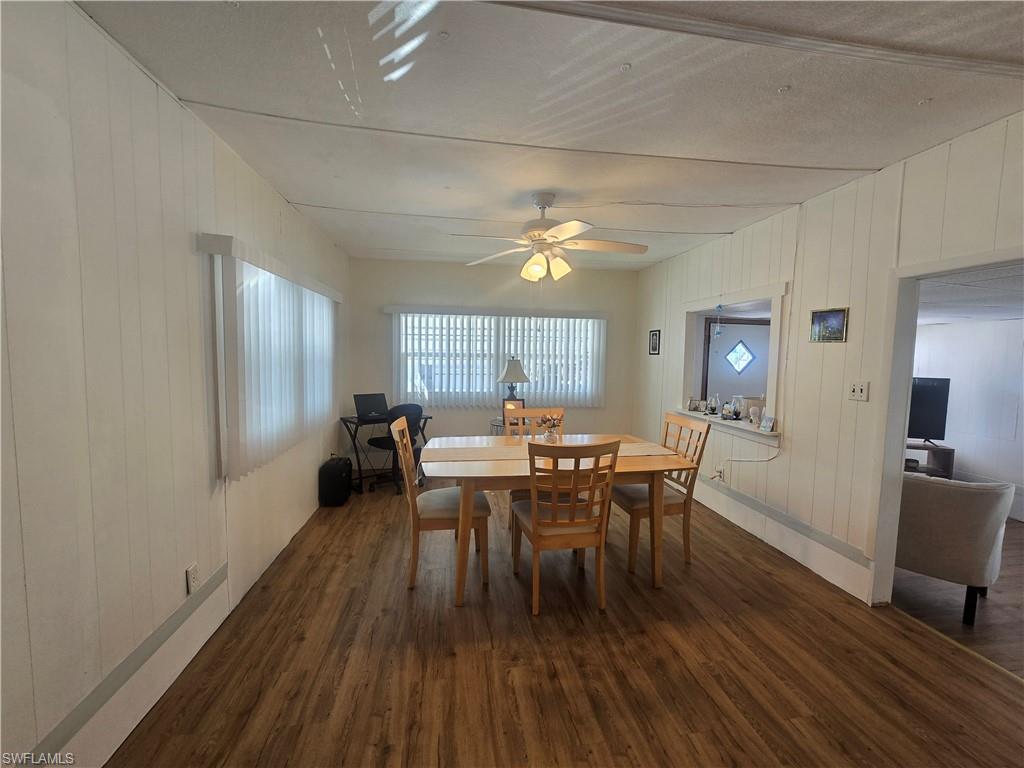 99 Moorhead Manor, Unit 99 Naples, FL 34112 - Photo 5 of 26 a view of a dining room with furniture window and wooden floor