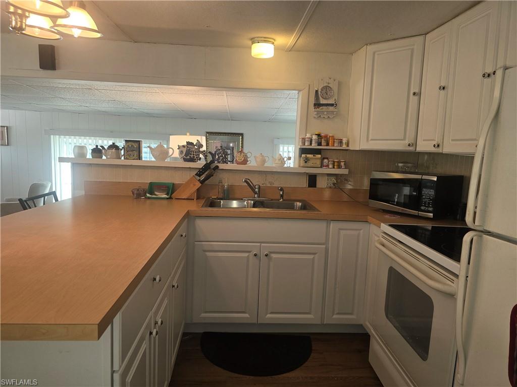 99 Moorhead Manor, Unit 99 Naples, FL 34112 - Photo 6 of 26 a kitchen with a sink and cabinets