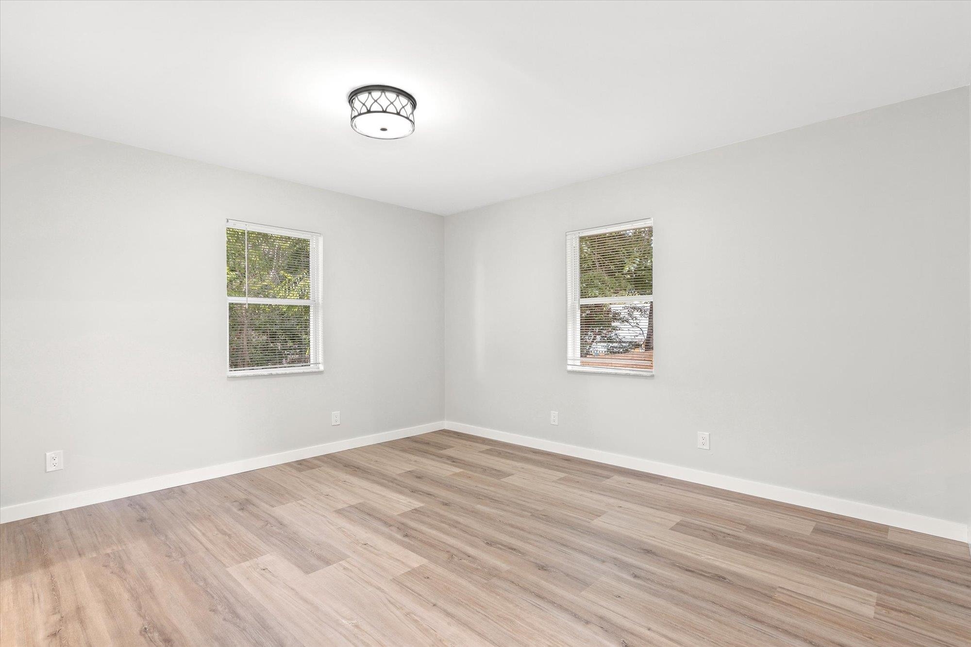 28 Sebastian Avenue, Unit D St. Augustine, FL 32084 - Photo 11 of 23 a view of a room with wooden floor and window