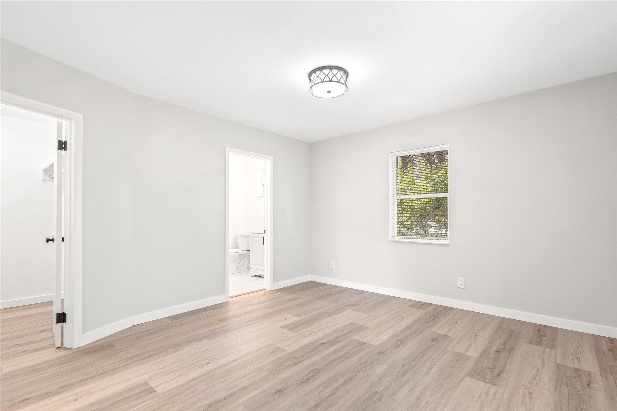 28 Sebastian Avenue, Unit D St. Augustine, FL 32084 - Photo 12 of 23 an empty room with wooden floor and windows