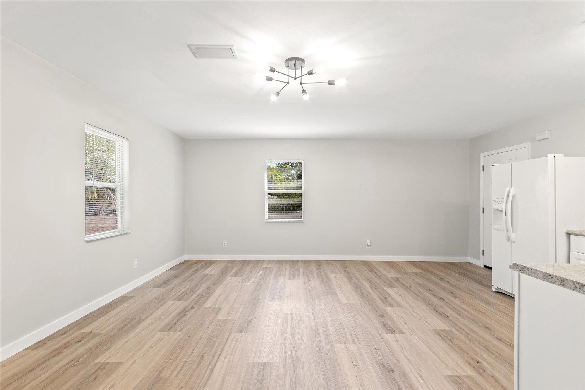 28 Sebastian Avenue, Unit D St. Augustine, FL 32084 - Photo 10 of 23 wooden floor in an empty room with a window