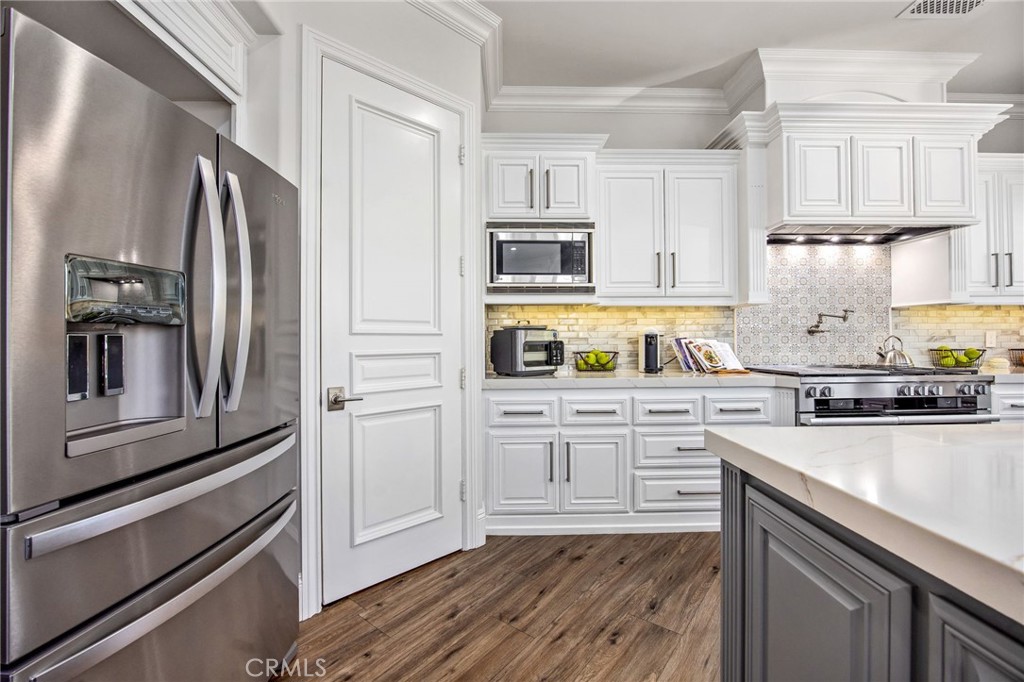 4709 Briana Court Fallbrook, CA 92028 - Photo 17 of 57 a kitchen with granite countertop stainless steel appliances and wooden cabinets