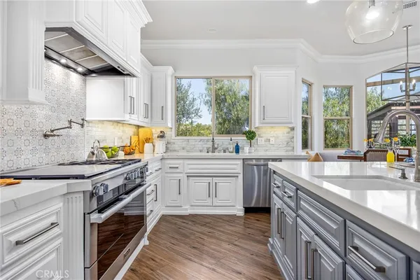 a kitchen with a sink stove top oven and cabinets