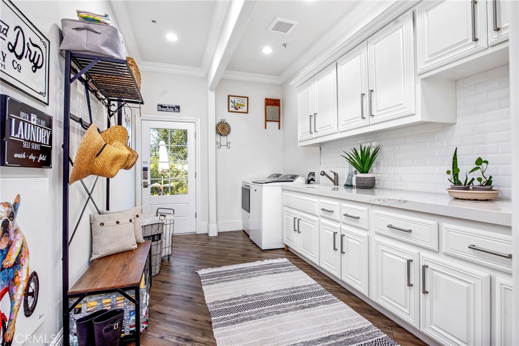 4709 Briana Court Fallbrook, CA 92028 - Photo 21 of 57 a large white kitchen with stainless steel appliances granite countertop a stove a sink a dining table and chairs with wooden floor