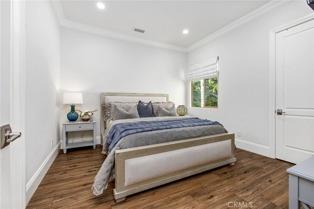 4709 Briana Court Fallbrook, CA 92028 - Photo 35 of 57 a bedroom with a bed and wooden floor