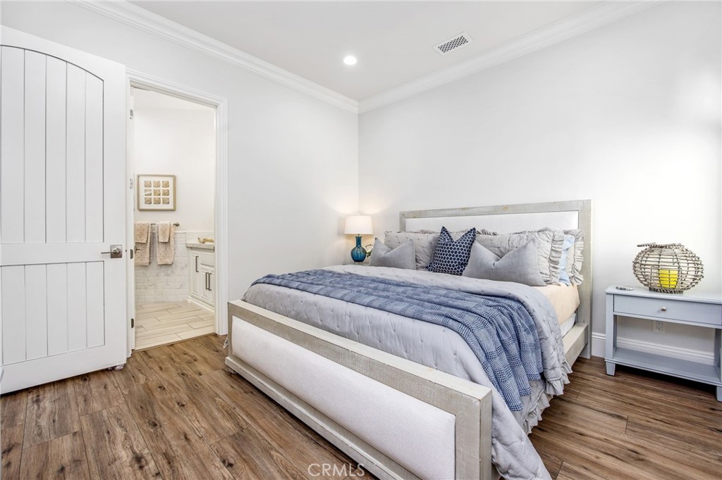 4709 Briana Court Fallbrook, CA 92028 - Photo 36 of 57 a bedroom with a bed and wooden floor