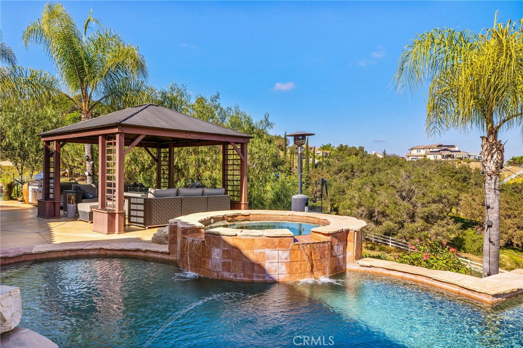 4709 Briana Court Fallbrook, CA 92028 - Photo 40 of 57 a view of a swimming pool with an outdoor seating and a yard