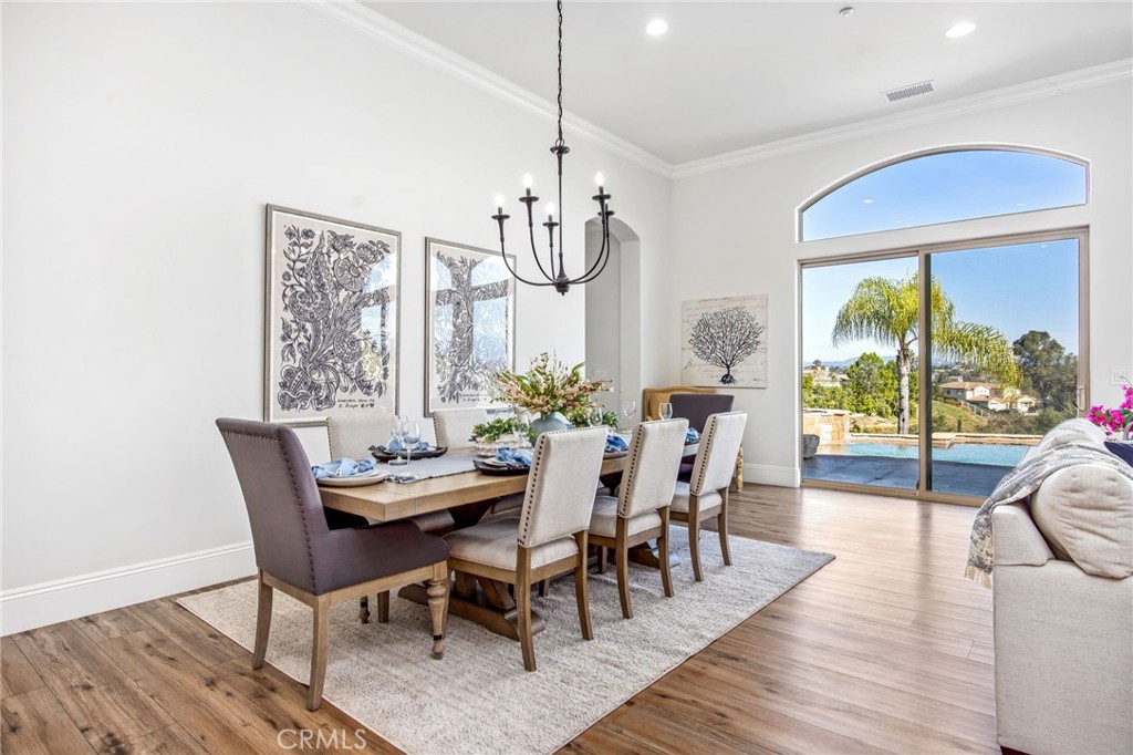 4709 Briana Court Fallbrook, CA 92028 - Photo 9 of 57 a view of a dining room with furniture a chandelier and wooden floor