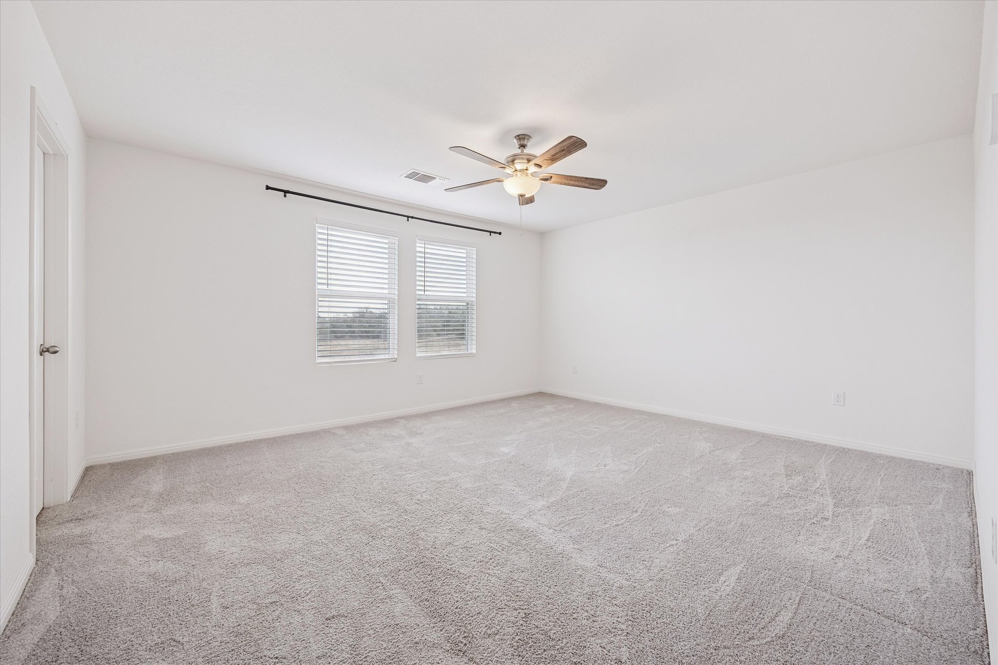 208 Night Riders Way Jarrell, TX 76537 - Photo 12 of 31 an empty room with windows and ceiling fan