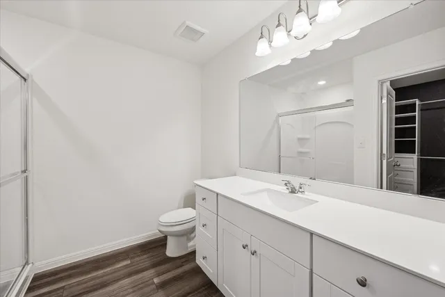 a bathroom with a double vanity sink mirror and toilet