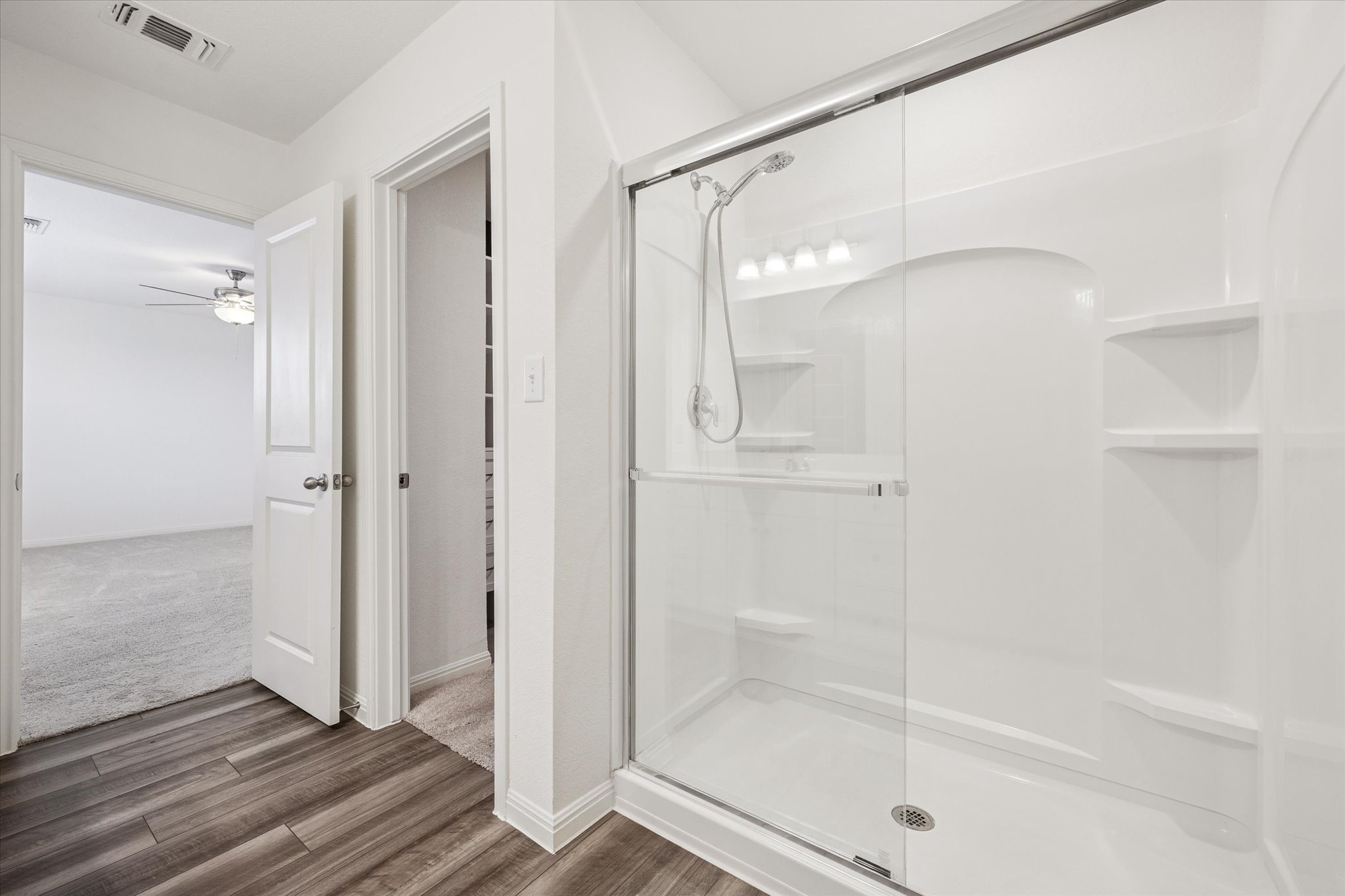 208 Night Riders Way Jarrell, TX 76537 - Photo 16 of 31 a bathroom with a glass shower door and a window