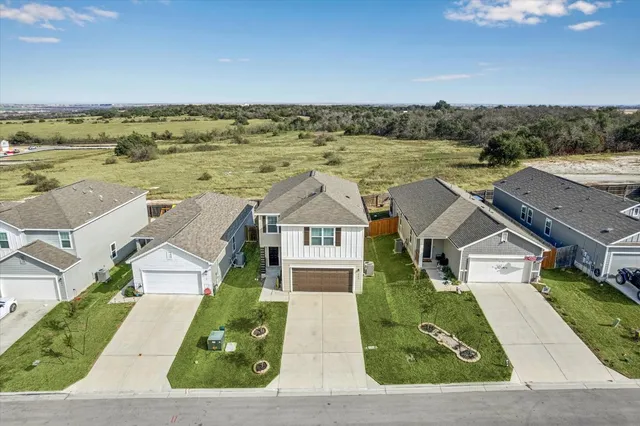 an aerial view of residential houses with outdoor space
