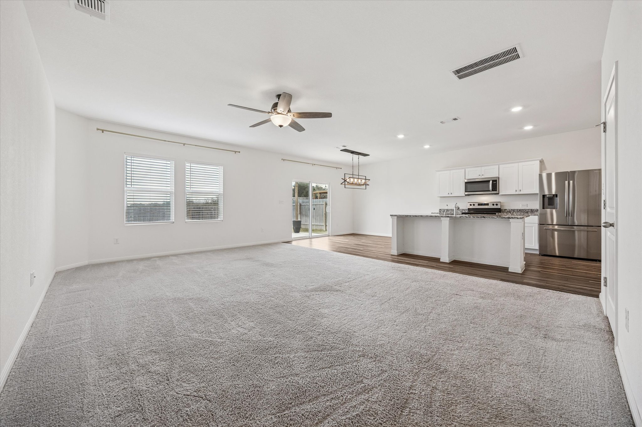 208 Night Riders Way Jarrell, TX 76537 - Photo 5 of 31 a view of a kitchen with a sink and a refrigerator