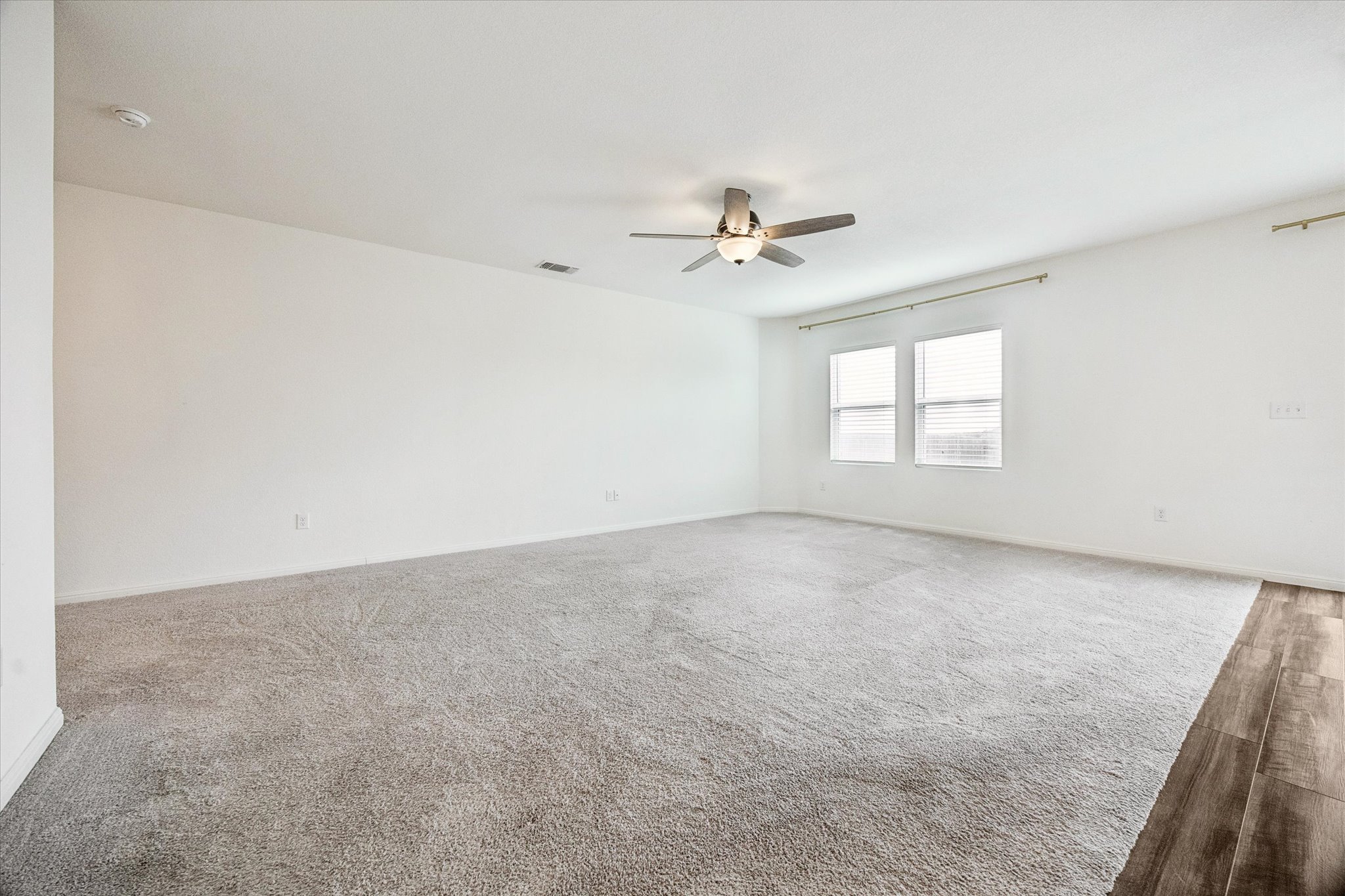 208 Night Riders Way Jarrell, TX 76537 - Photo 7 of 31 an empty room with windows and ceiling fan
