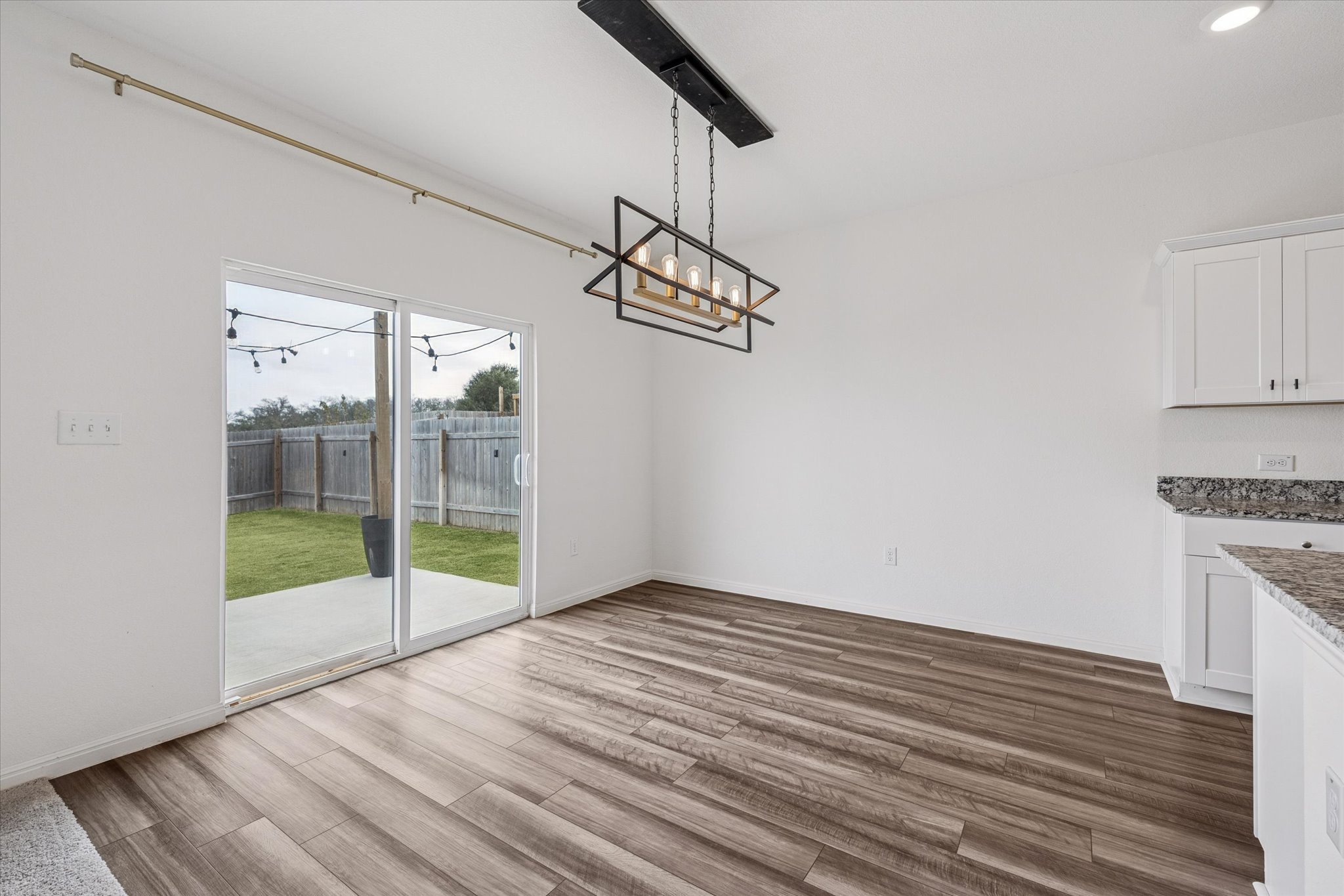 208 Night Riders Way Jarrell, TX 76537 - Photo 9 of 31 a view of empty room with wooden floor and fan