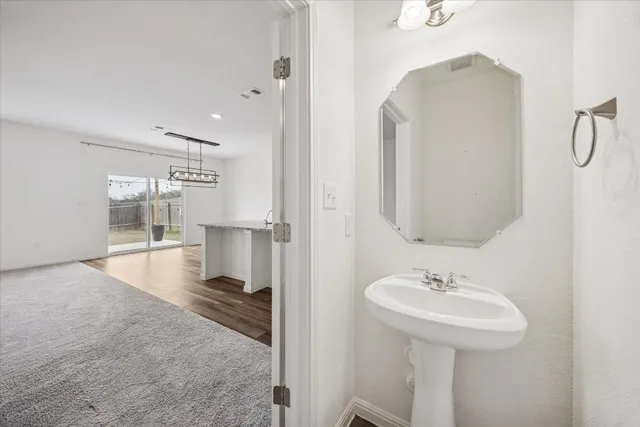a bathroom with a sink and mirror