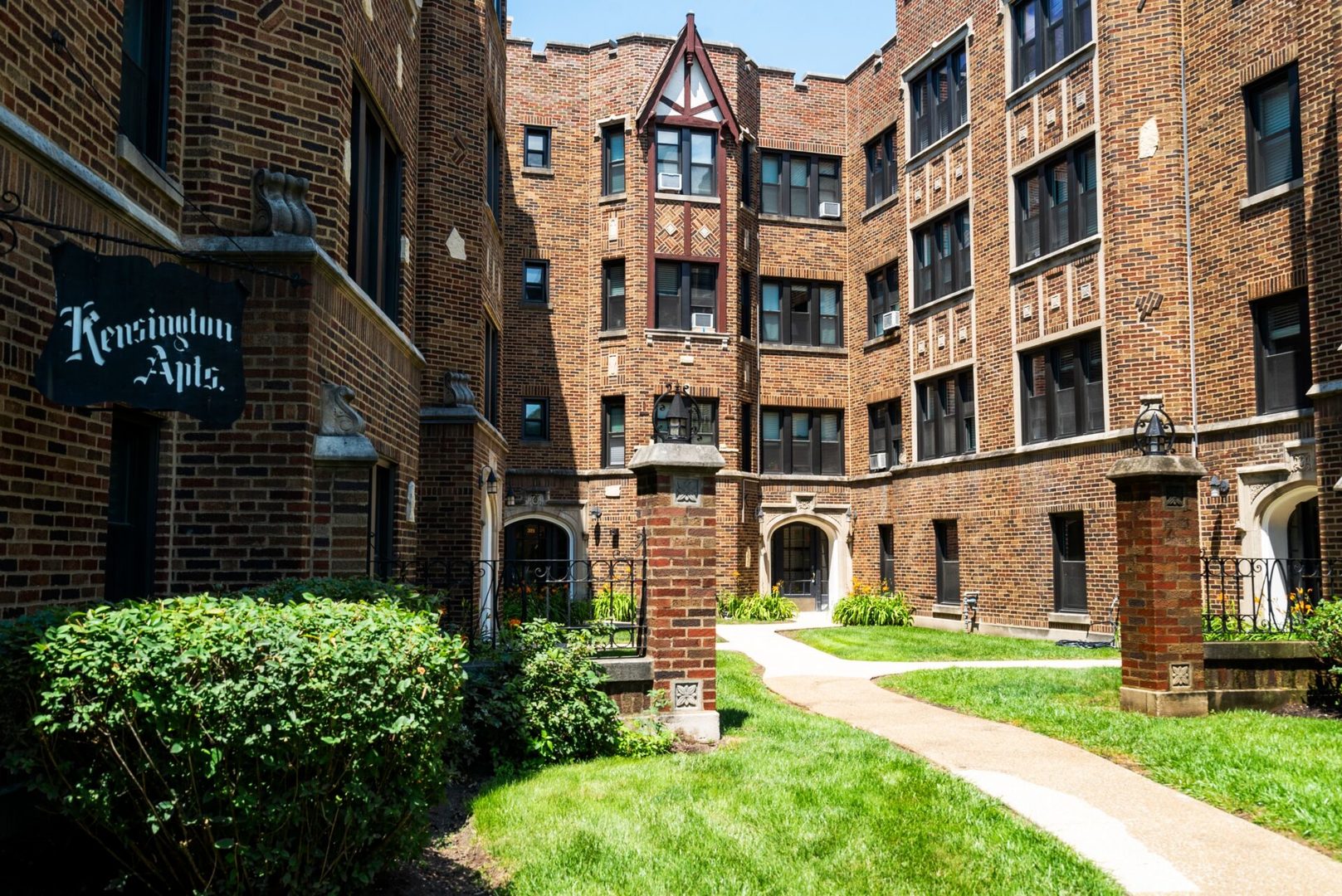 a view of a brick building next to a yard