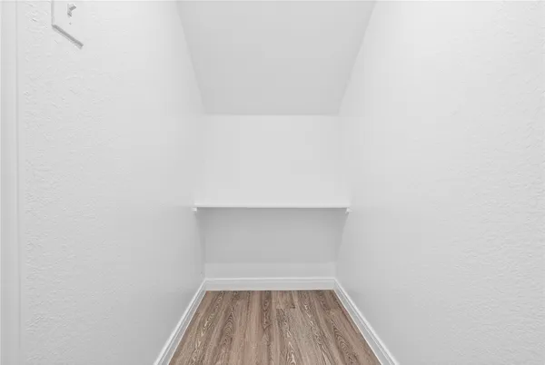 a view of room with wooden floor