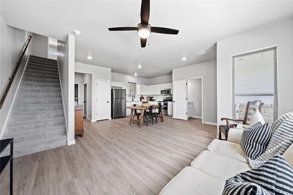 a living room with furniture and kitchen view