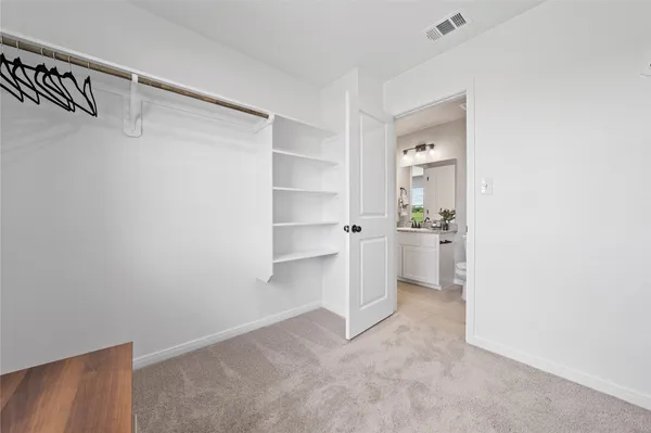 a view of a kitchen with white cabinets