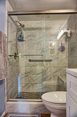 a bathroom with a toilet and a shower