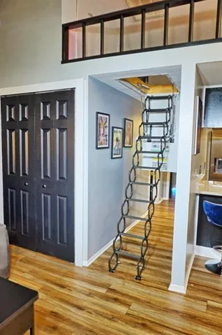 a view of entryway and hall with wooden floor