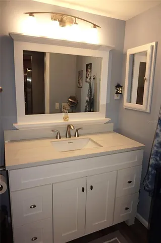 a bathroom with a sink and a mirror