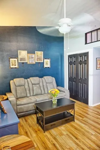 a bedroom with furniture and wooden floor